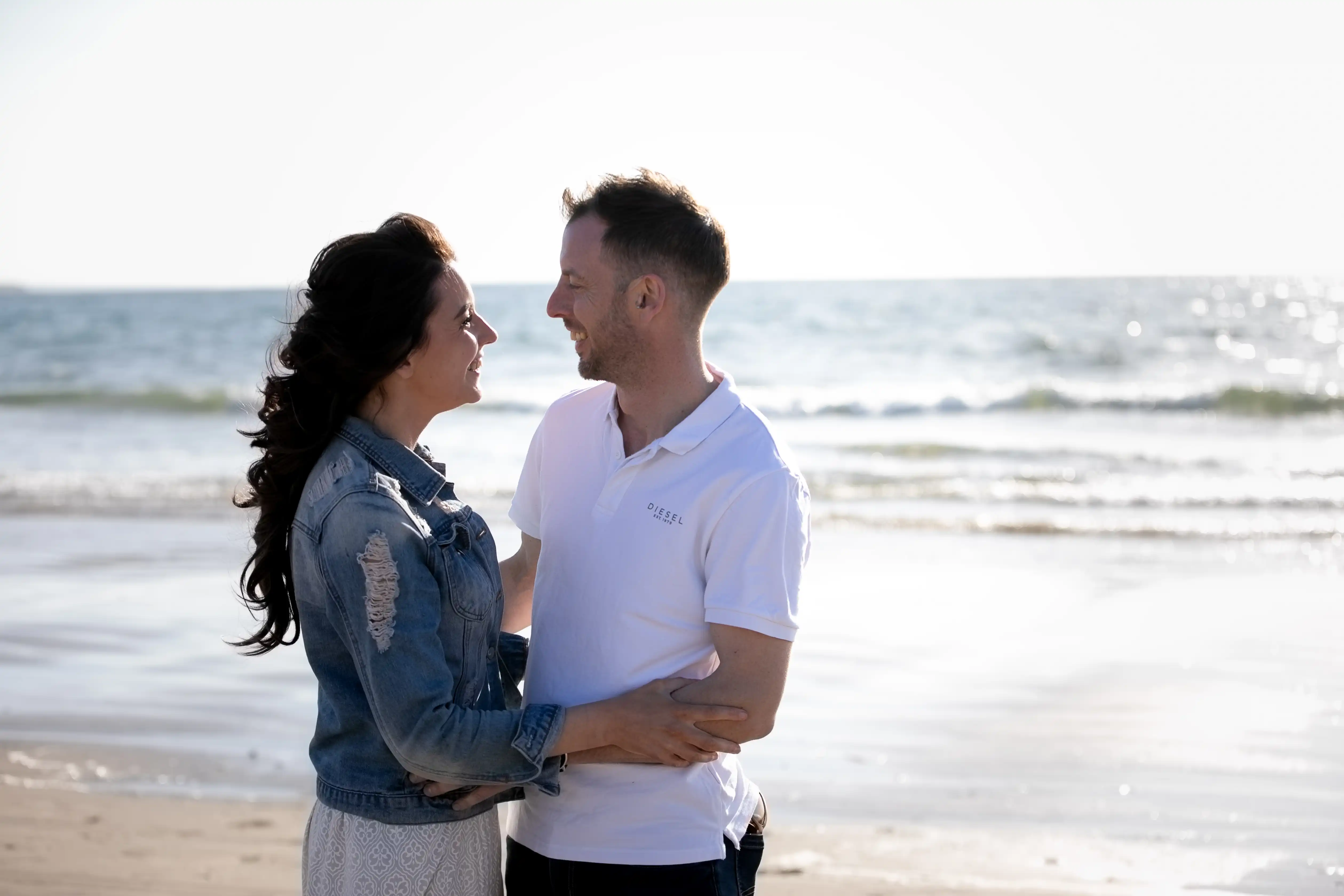 Couple embracing and smiling on beach