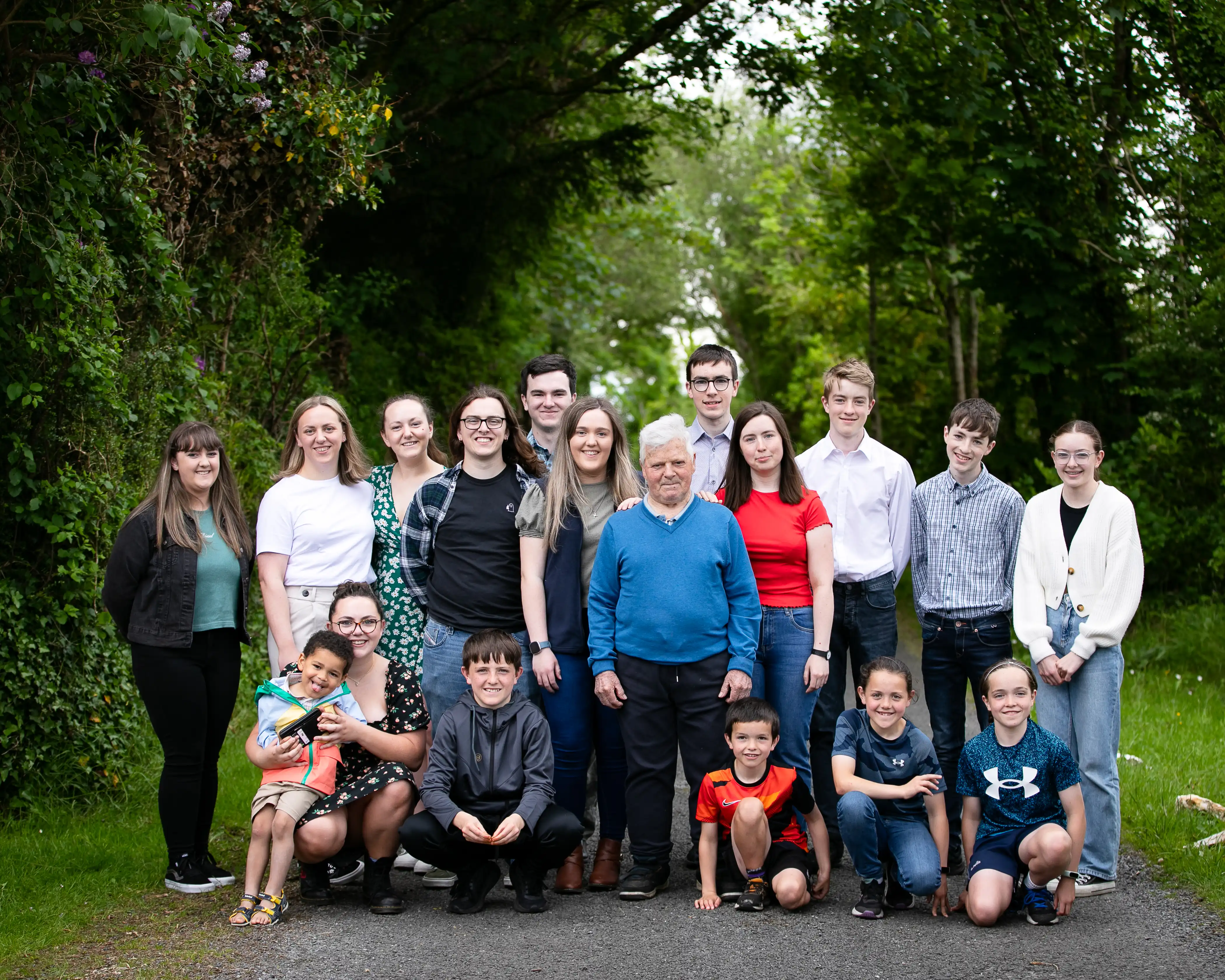 Grandad and grandkids standing on country road