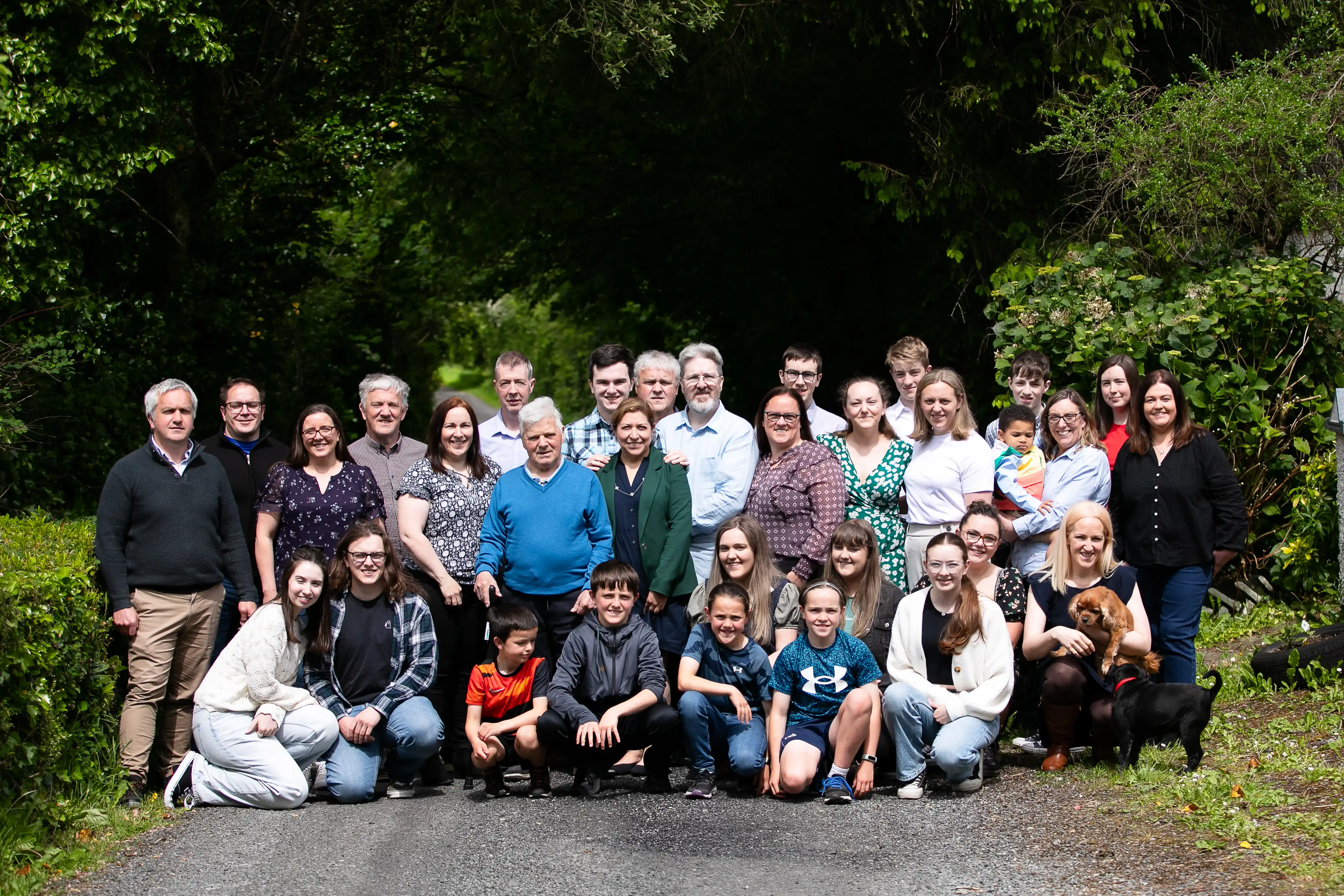 Full family posing for photo on country road