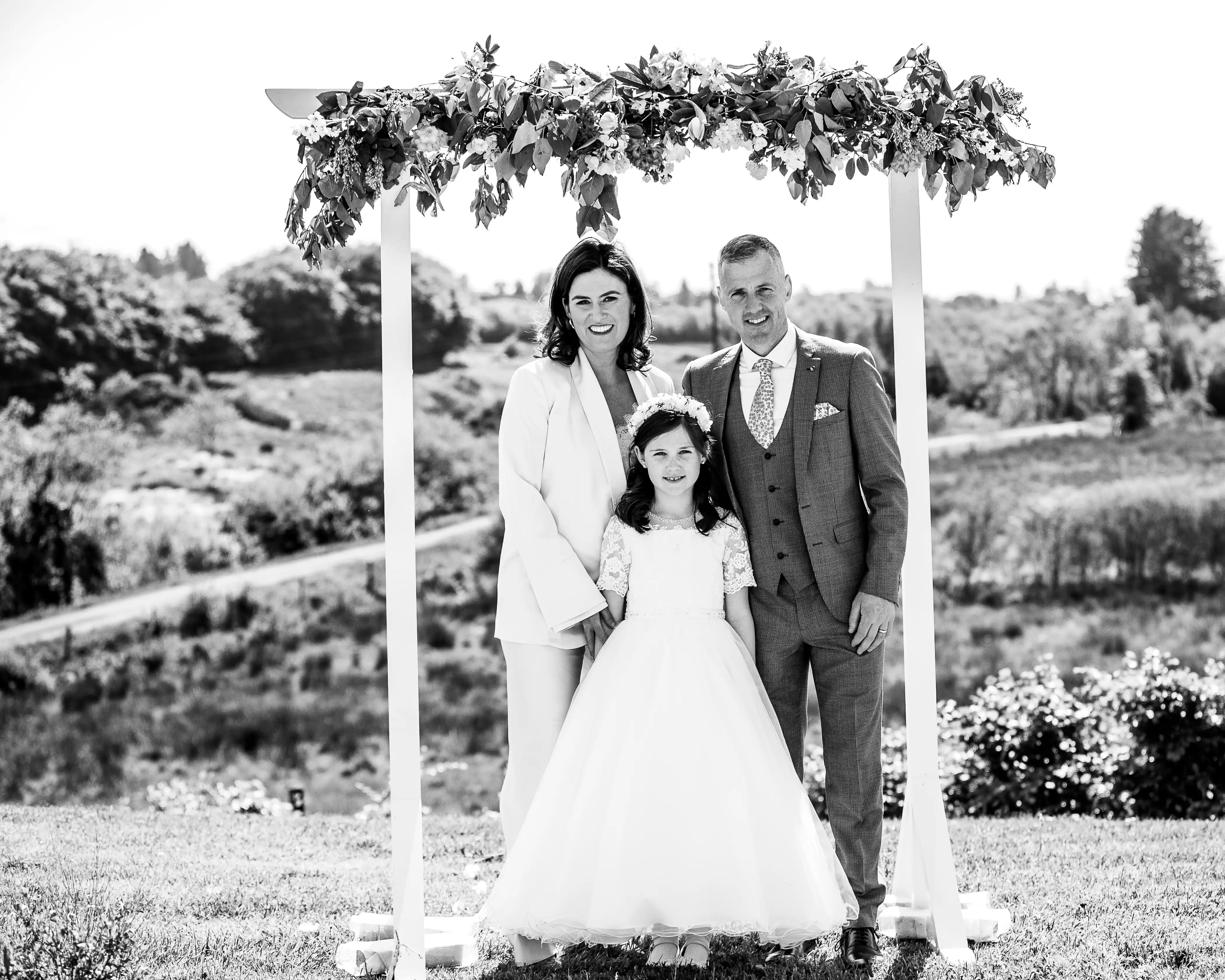 Mum and dad smiling with little girl on her communion day