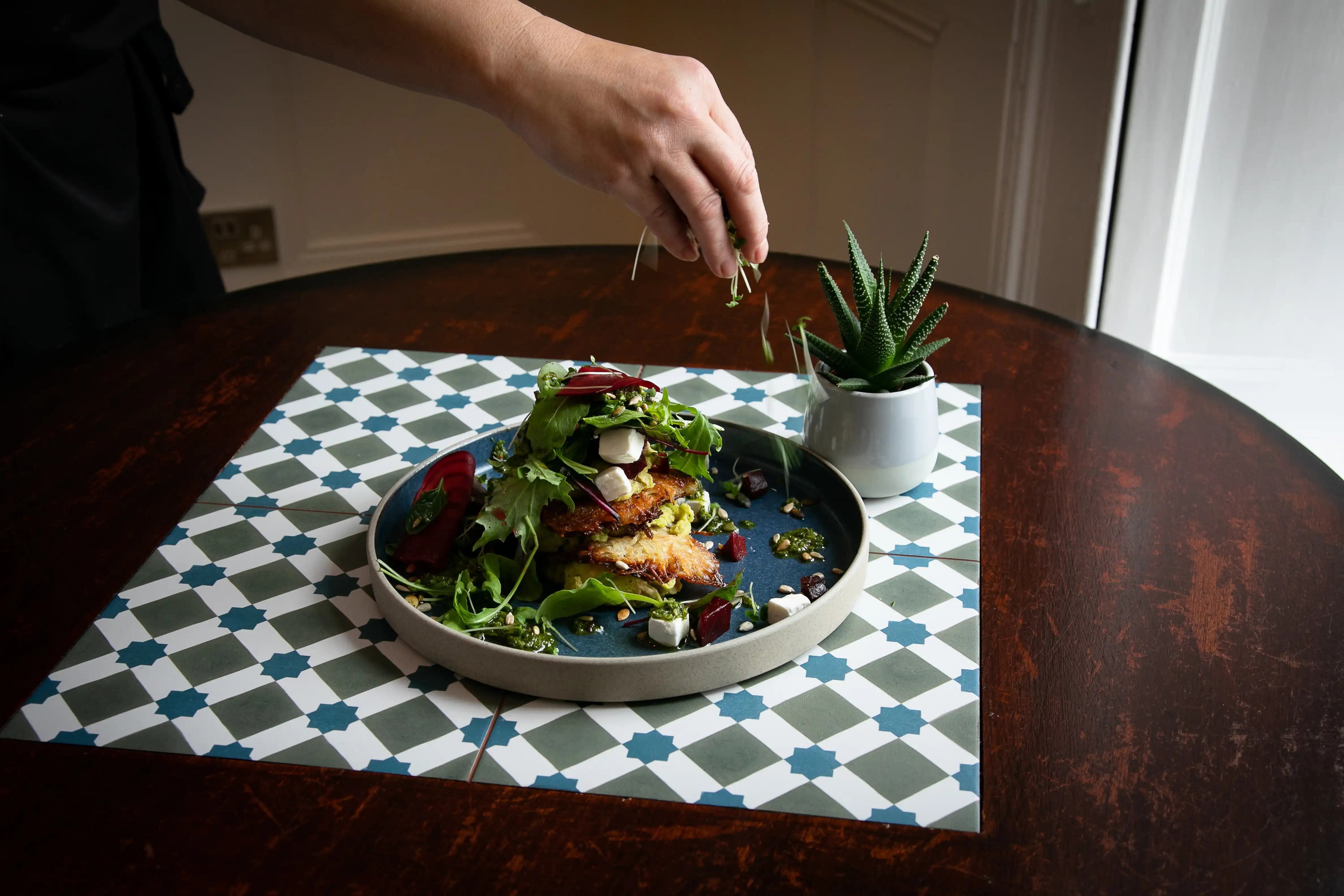 Delicious plate of foot beautifully presented being garnished by chef