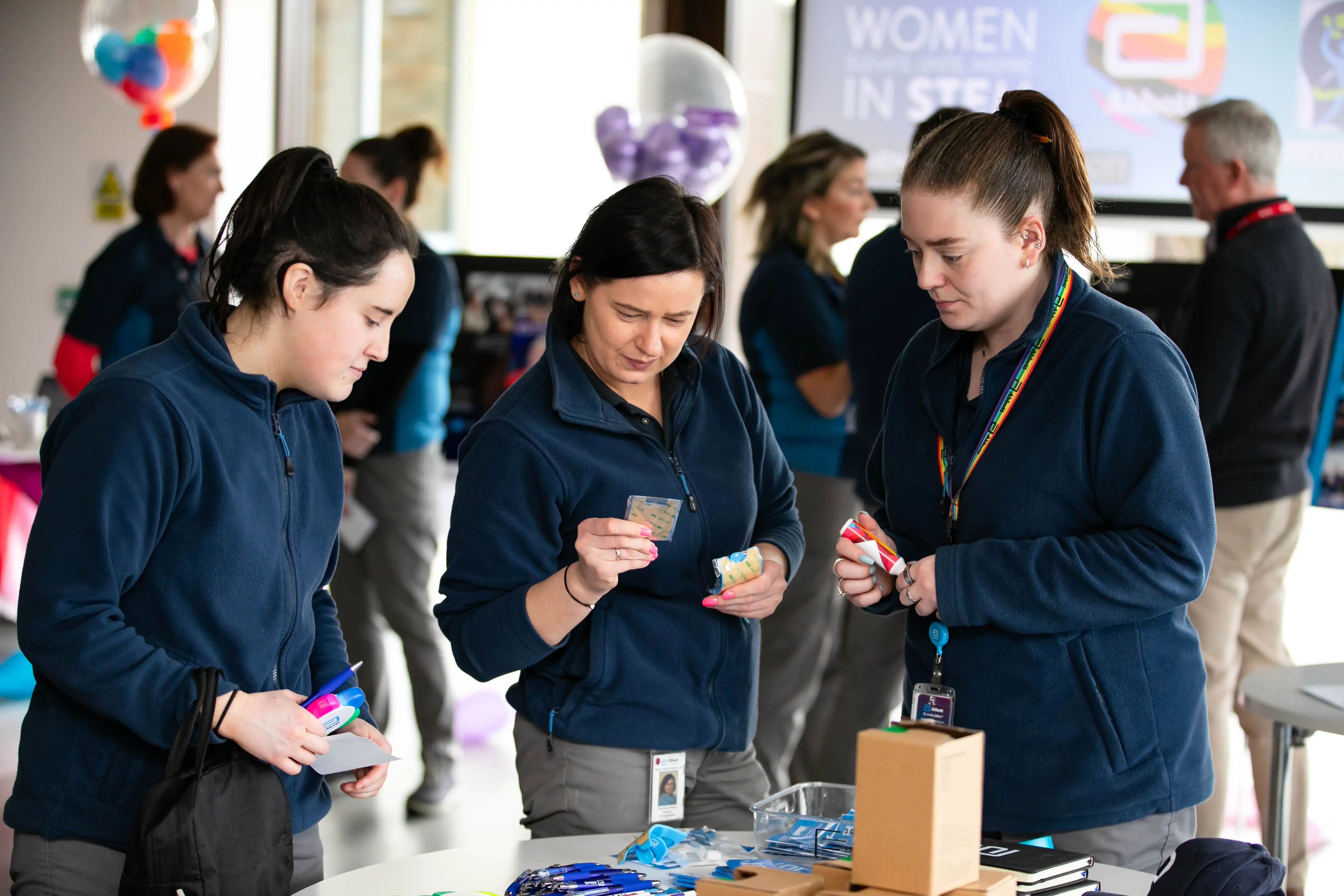 Office workers view stand at exhibition