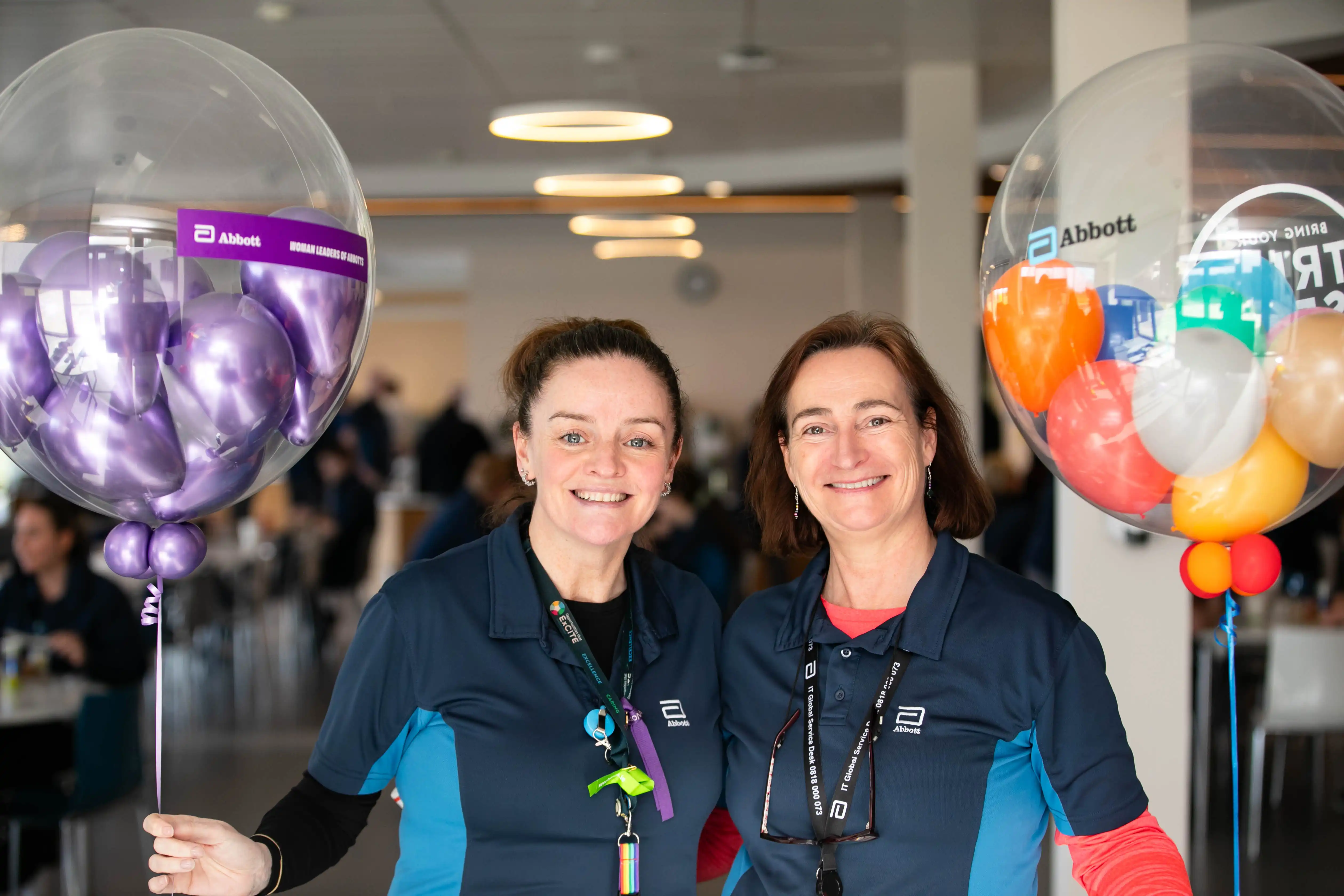 Office workers pose for photo with balloons 