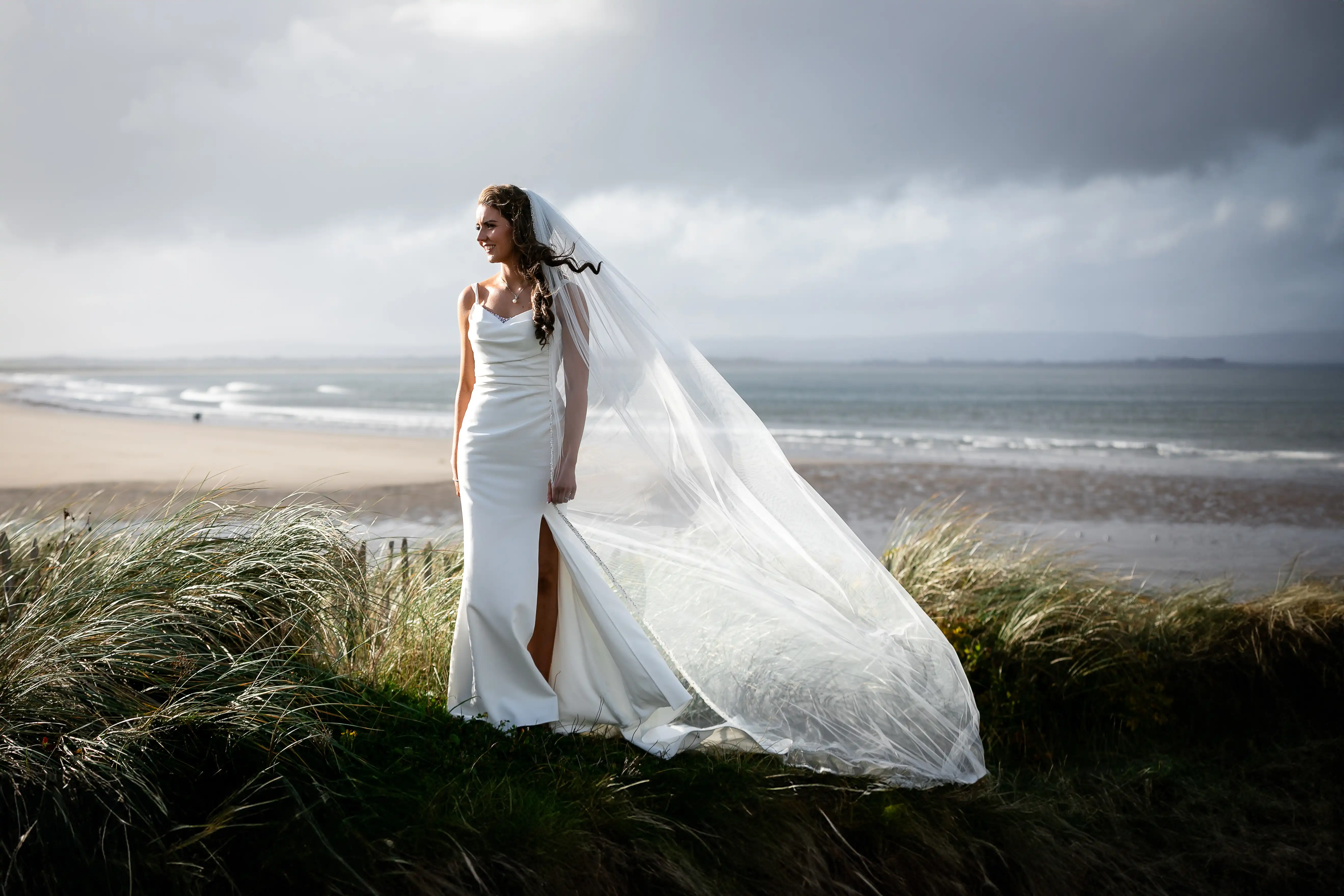 Bride standing in front of beach