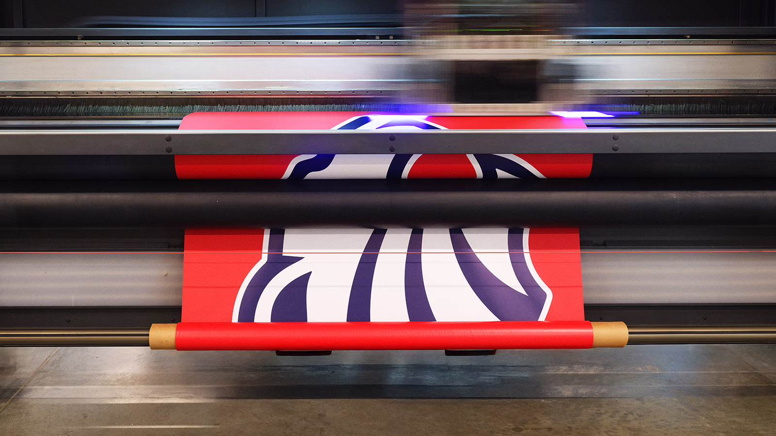 Close-up of a high-tech printing machine producing vibrant, colorful prints on glossy paper.