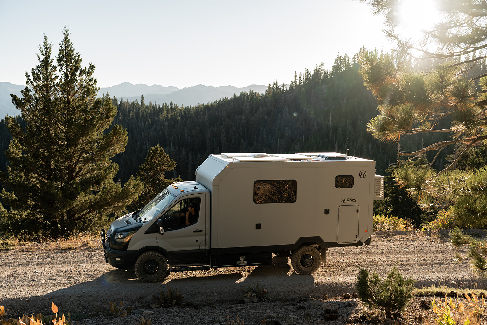 AEONrv in profile on a mountain road at golden hour, no hookups in sight