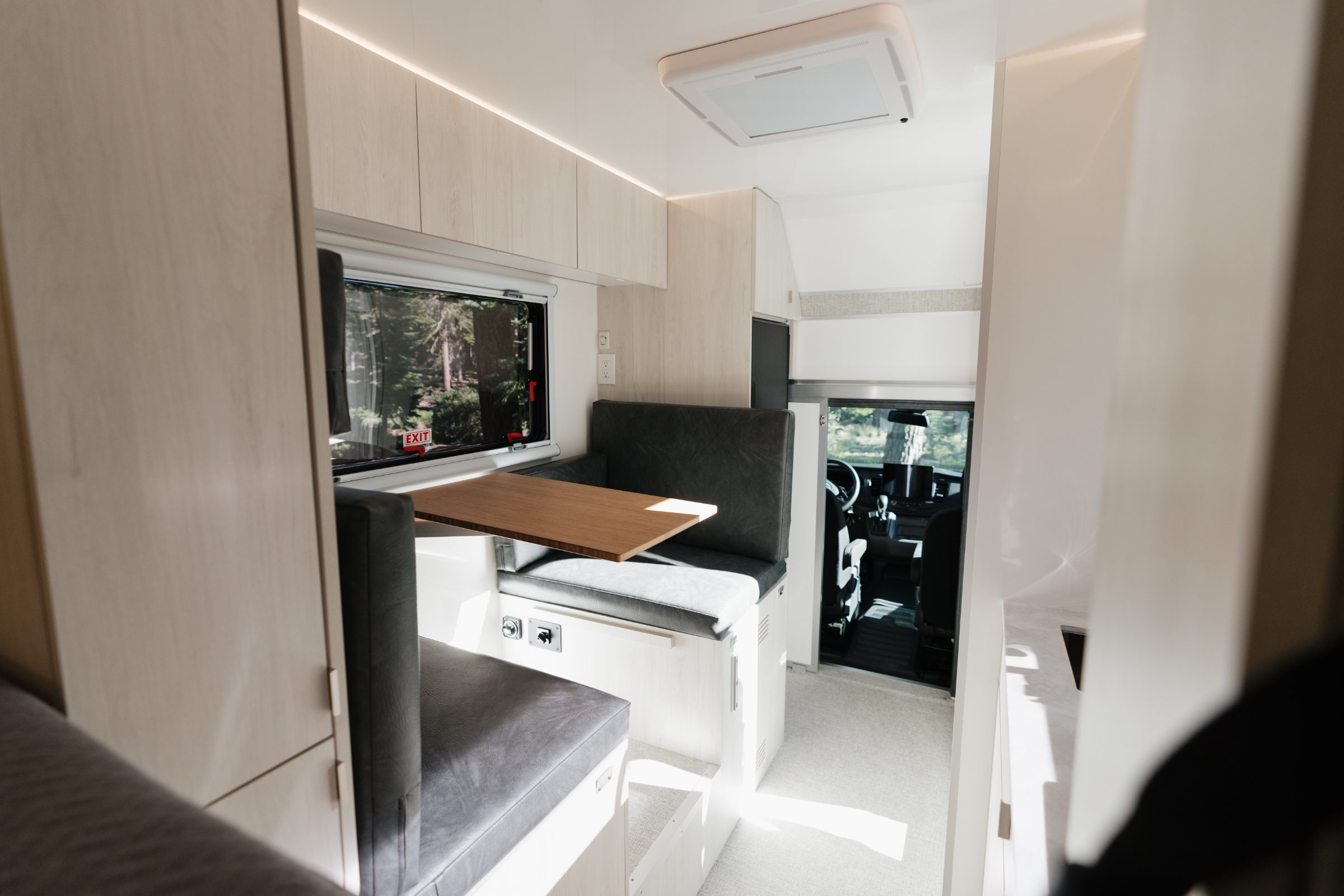 AEONrv dinette with the table set up, looking forward to the cab