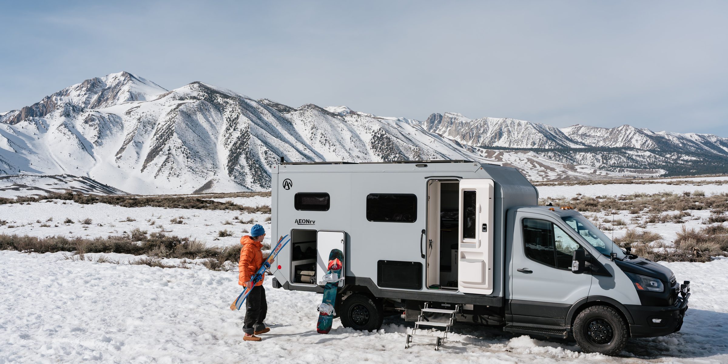 AEONrv parked in the snow below the Sierra, owners unloading skis