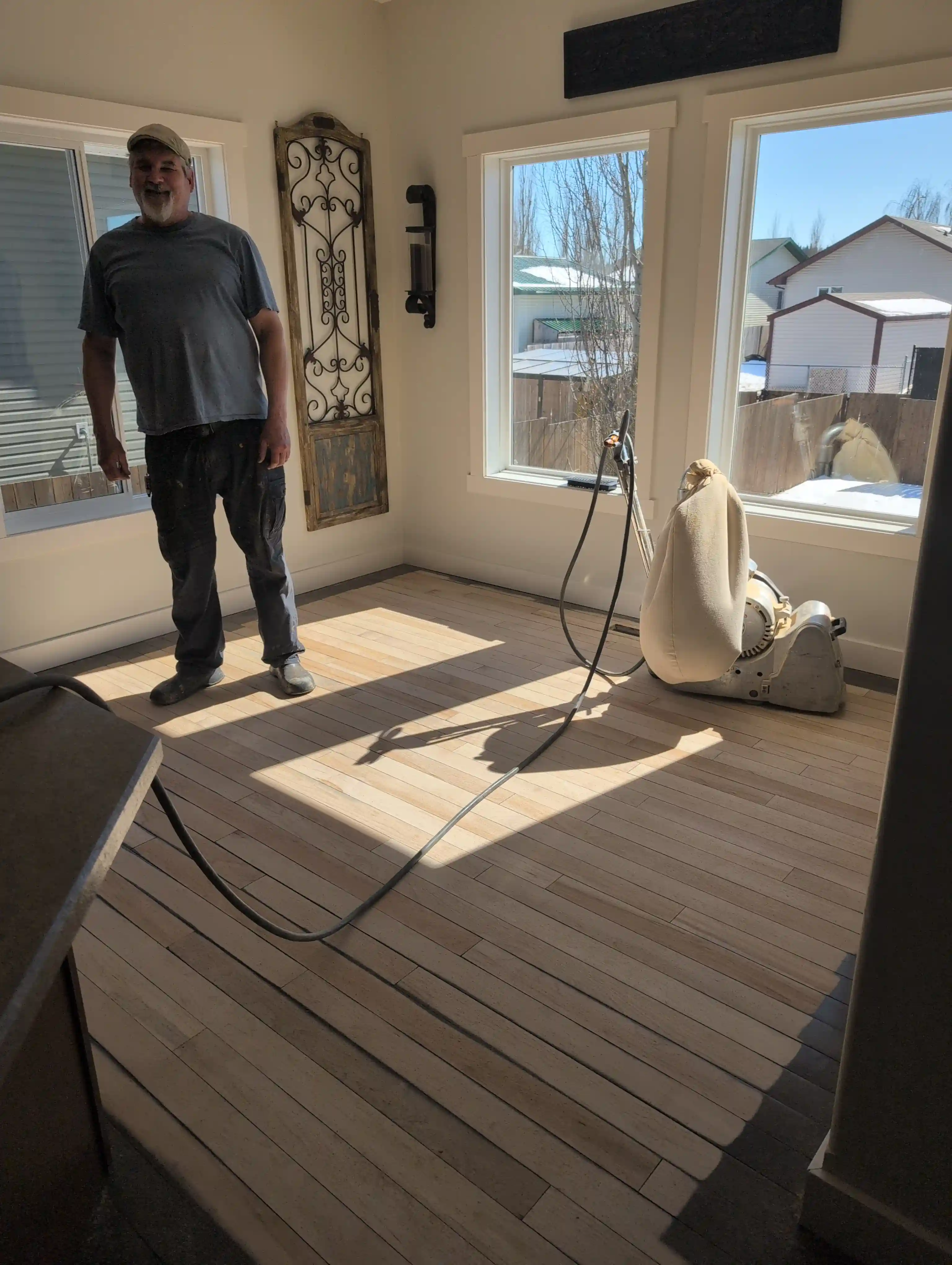 man in living room light hardwood