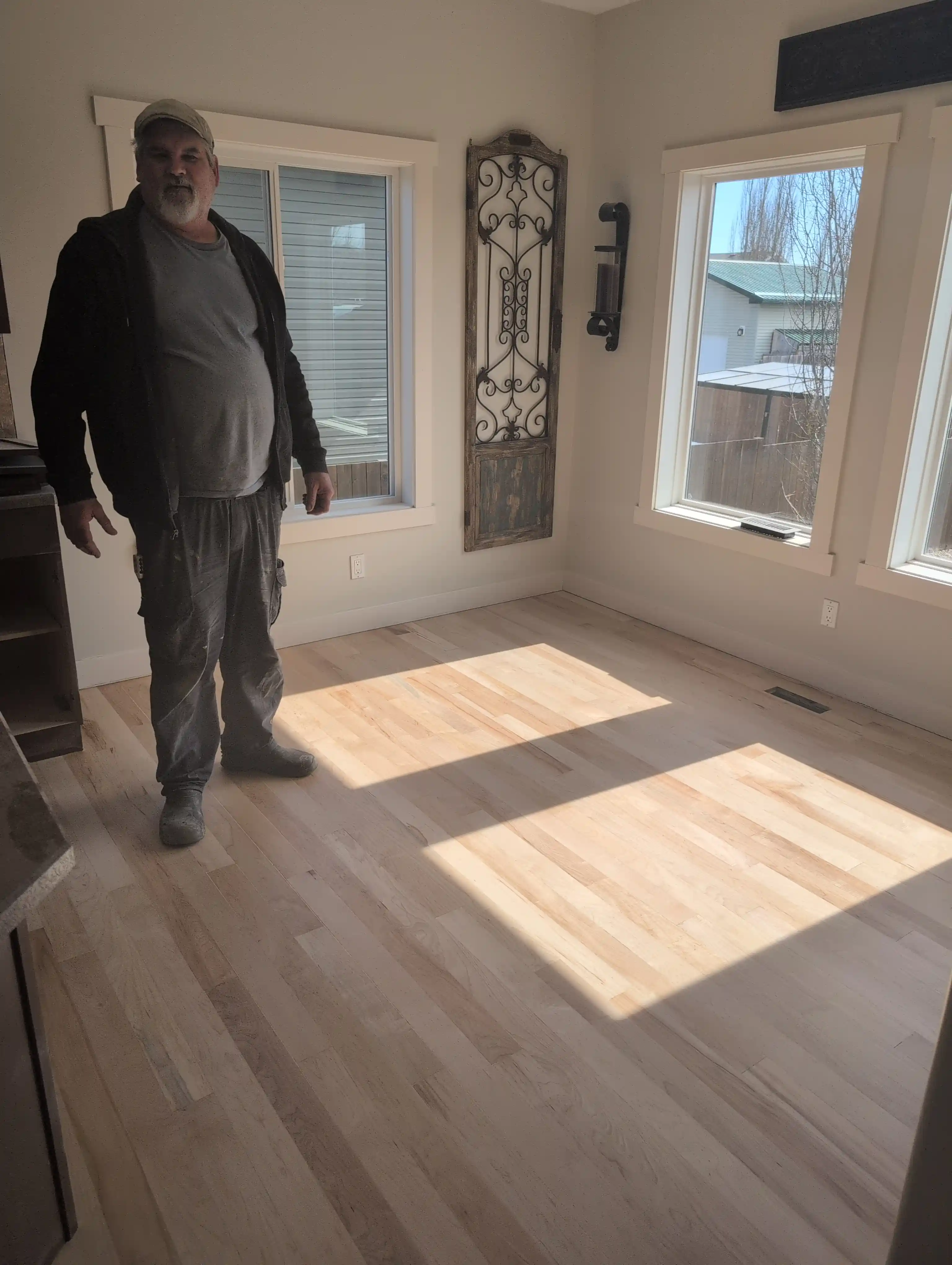man standing on hardwood floor in living room