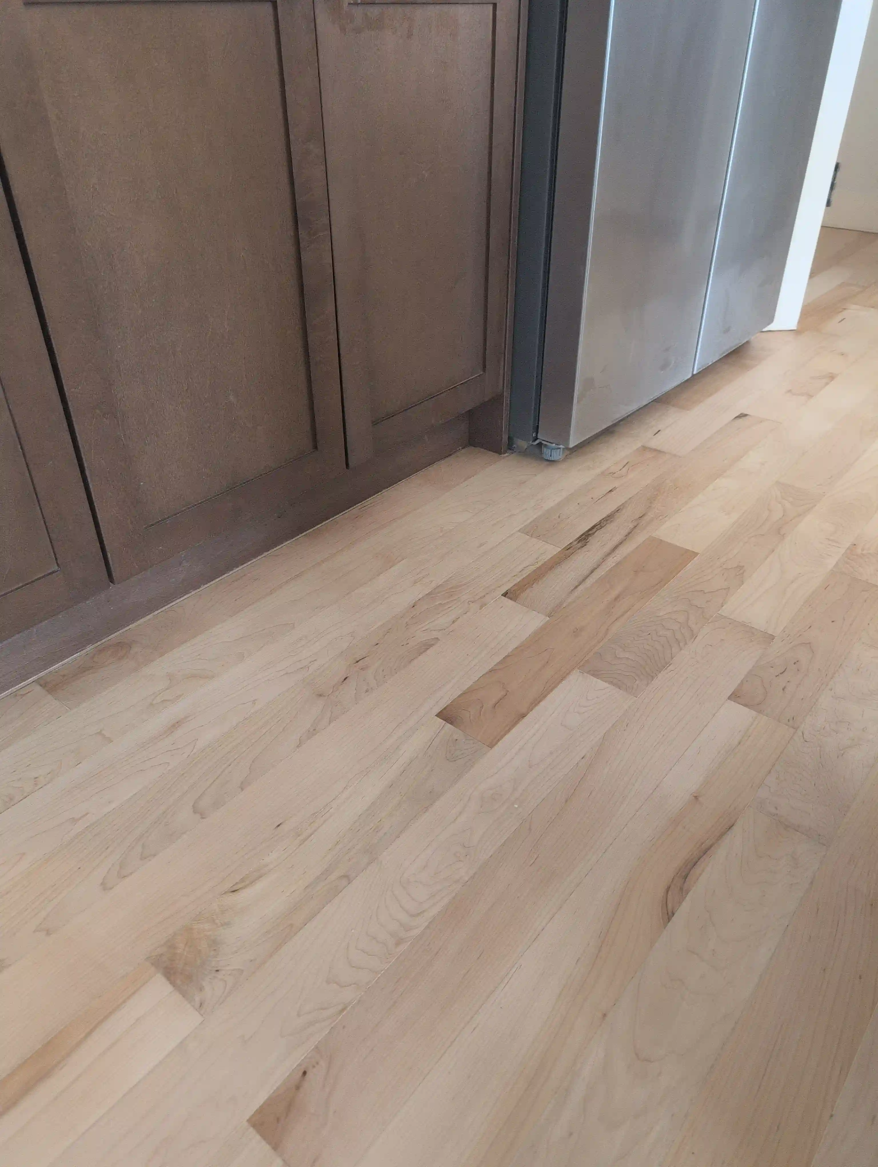 light hardwood in front of kitchen countertop and washer