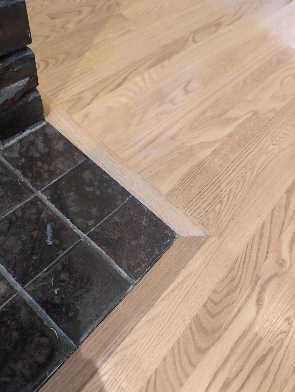 Hardwood seam next to fireplace hearth