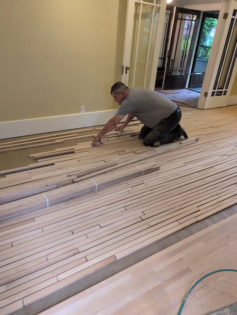 Carpenter applying new hardwood floors