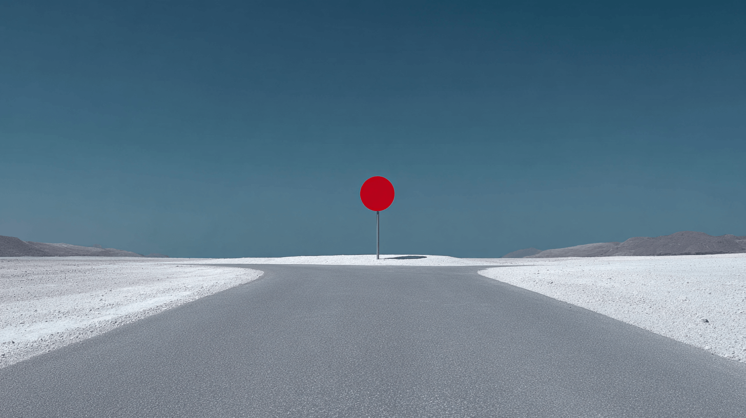 Red circular detour sign blocking a road in the middle of a barren landscape.
