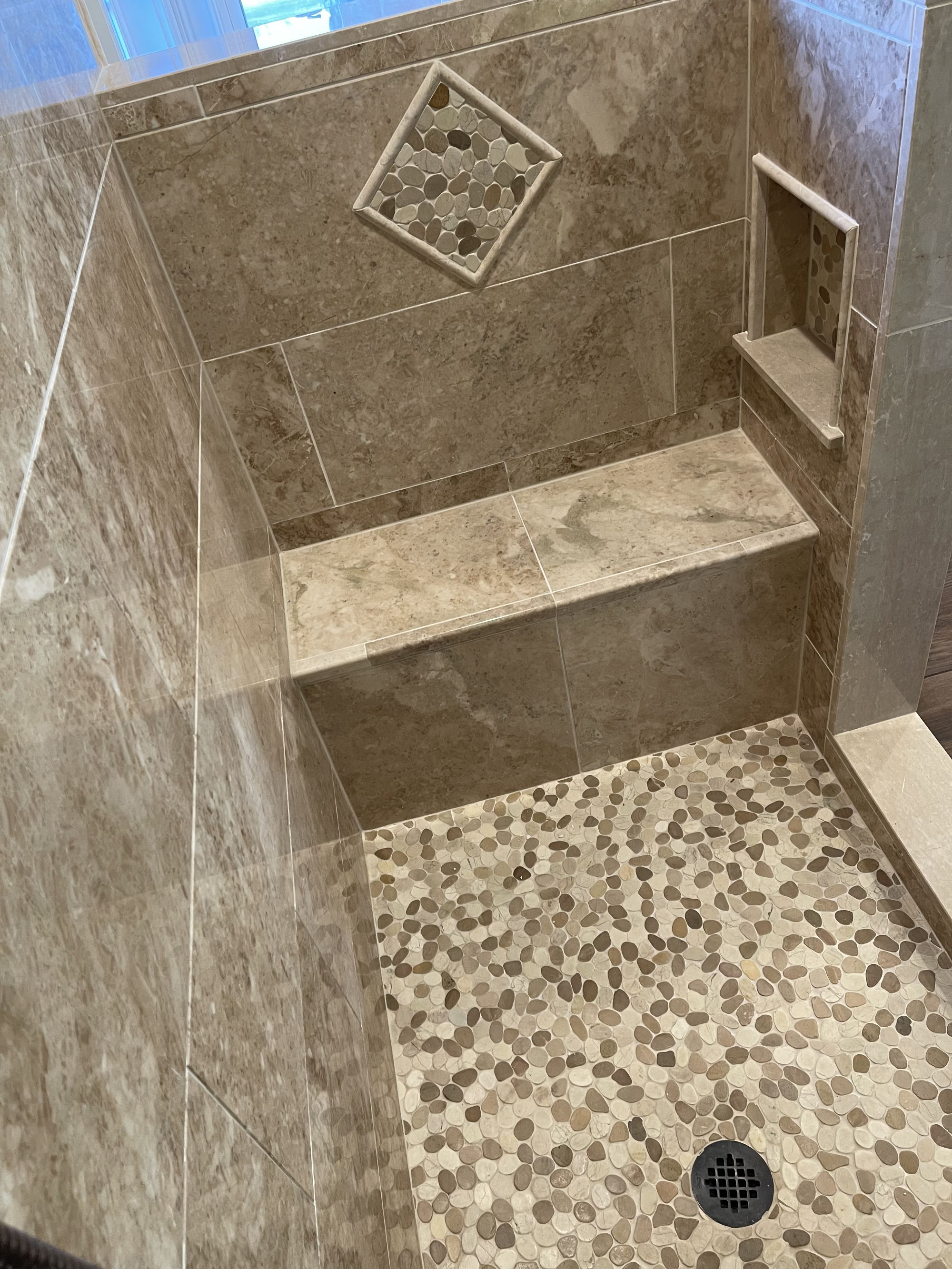 pebble tile shower floor and niche