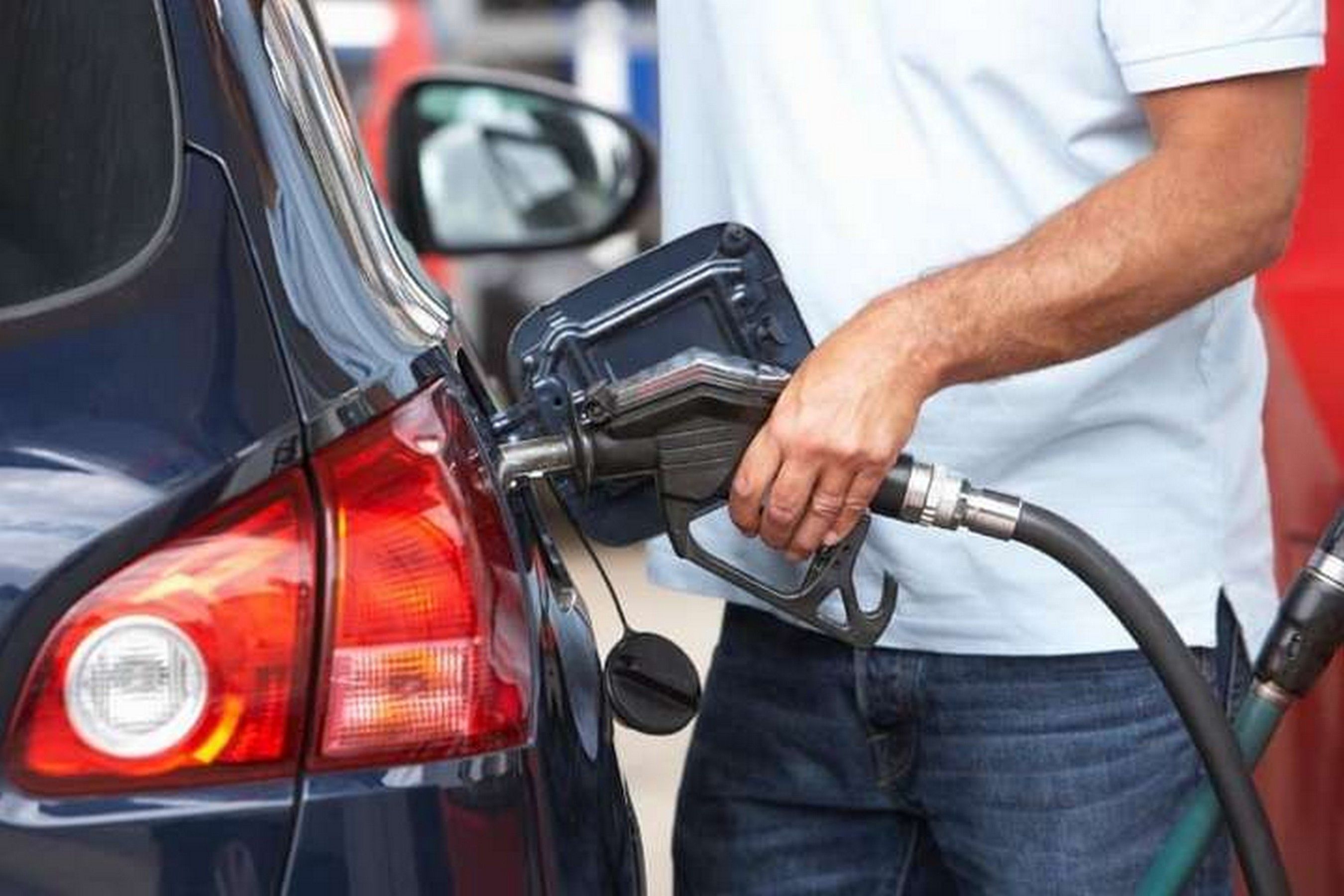 Driver filling a car with fuel at a petrol station