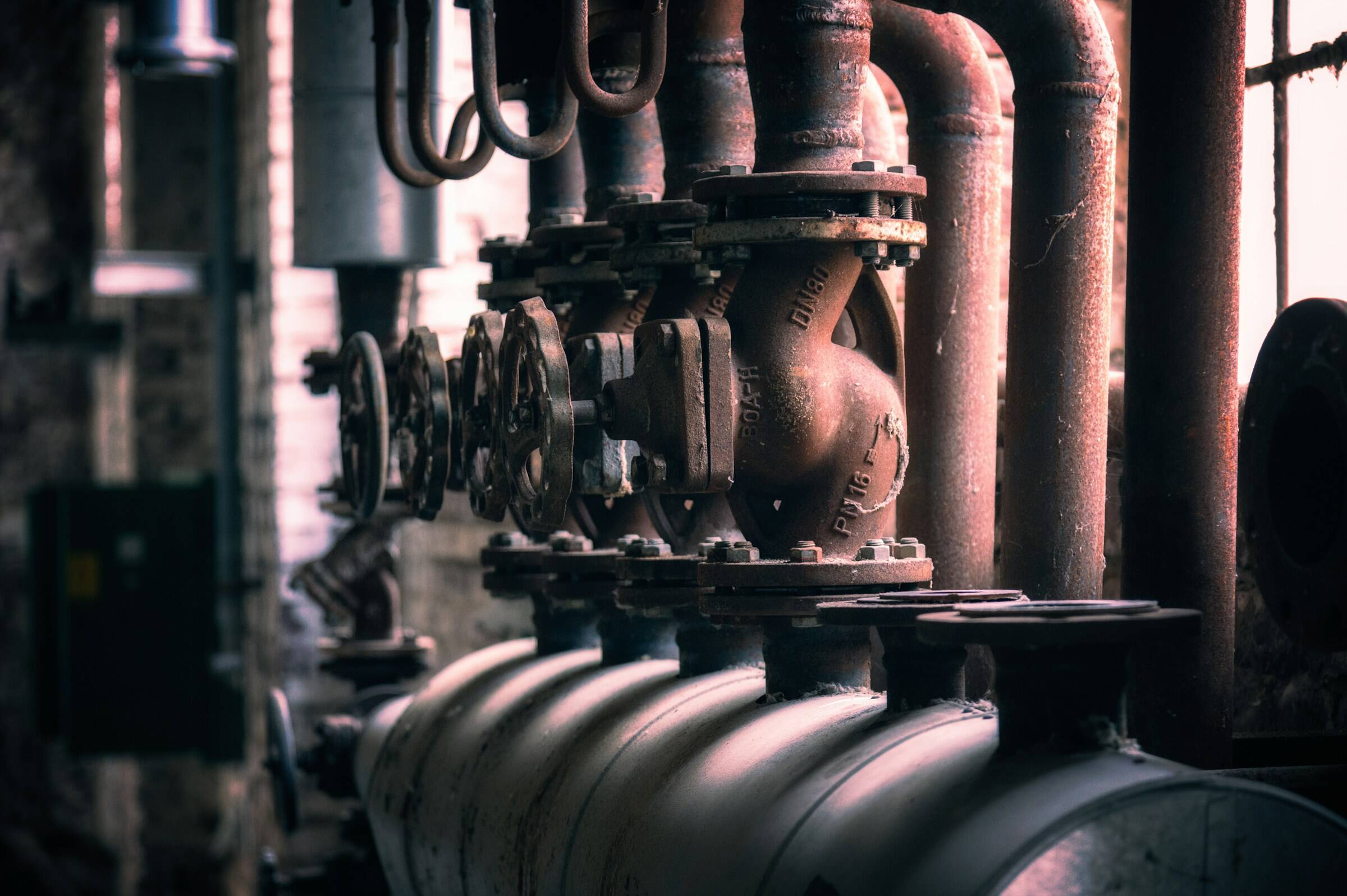 Industrial pipework and valves in a factory, an example of plant and machinery