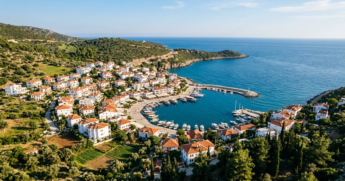 A whitewashed Mediterranean harbour town seen from above