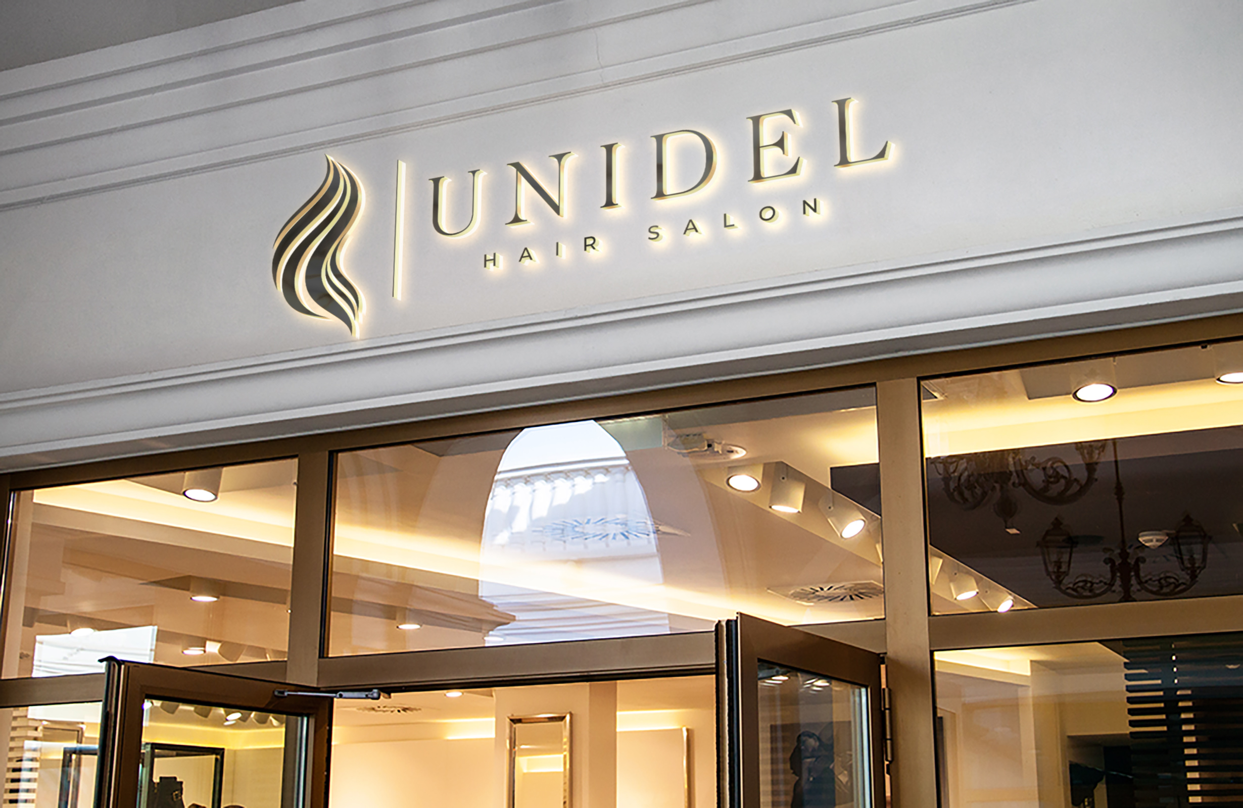 Unidel Hair Salon storefront signage mockup with illuminated lettering above the entrance.