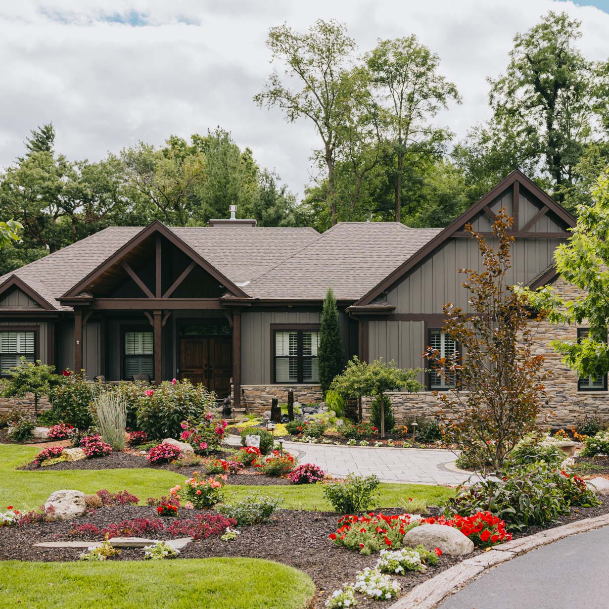 Beautiful front yard landscape with colorful flowers and manicured lawn at a suburban Chicago home.