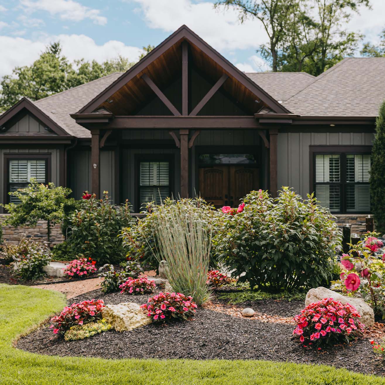 Pink hibiscus flowers and greenery enhancing curb appeal in suburban landscape