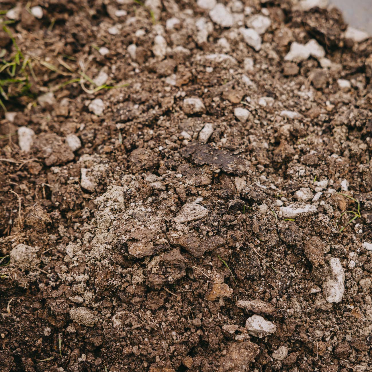 Close-up of garden soil and crushed gravel used in landscaping preparation