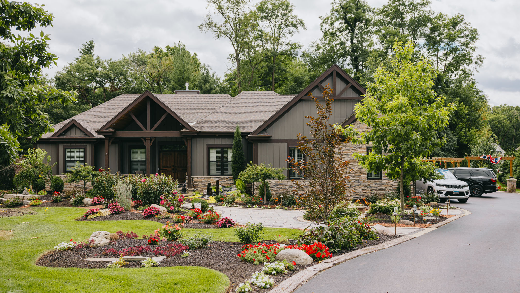 Front yard landscaping with lush flower beds and manicured lawn