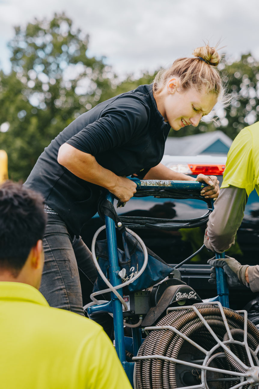 Landscaping team using heavy-duty equipment during an outdoor project installation