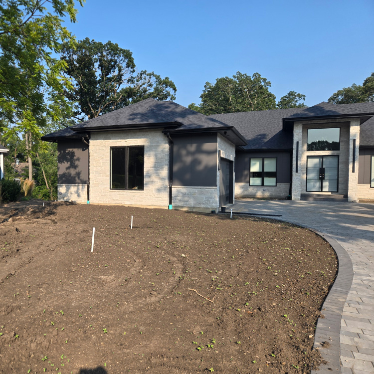 Front view of the Ranallo residence showing fresh soil prepared for landscaping installation.