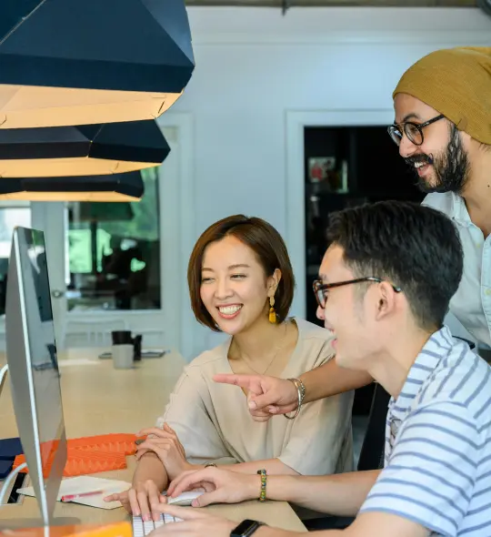 two coworkers exchanging positive feedback while working on a laptop
