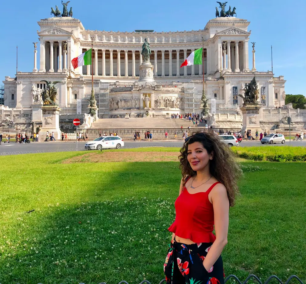 Parisa, standing in Piazza Venezia in Rome, in front of the Altare della Patria, during her Master's in Finance studies at the University of Tor Vergata.