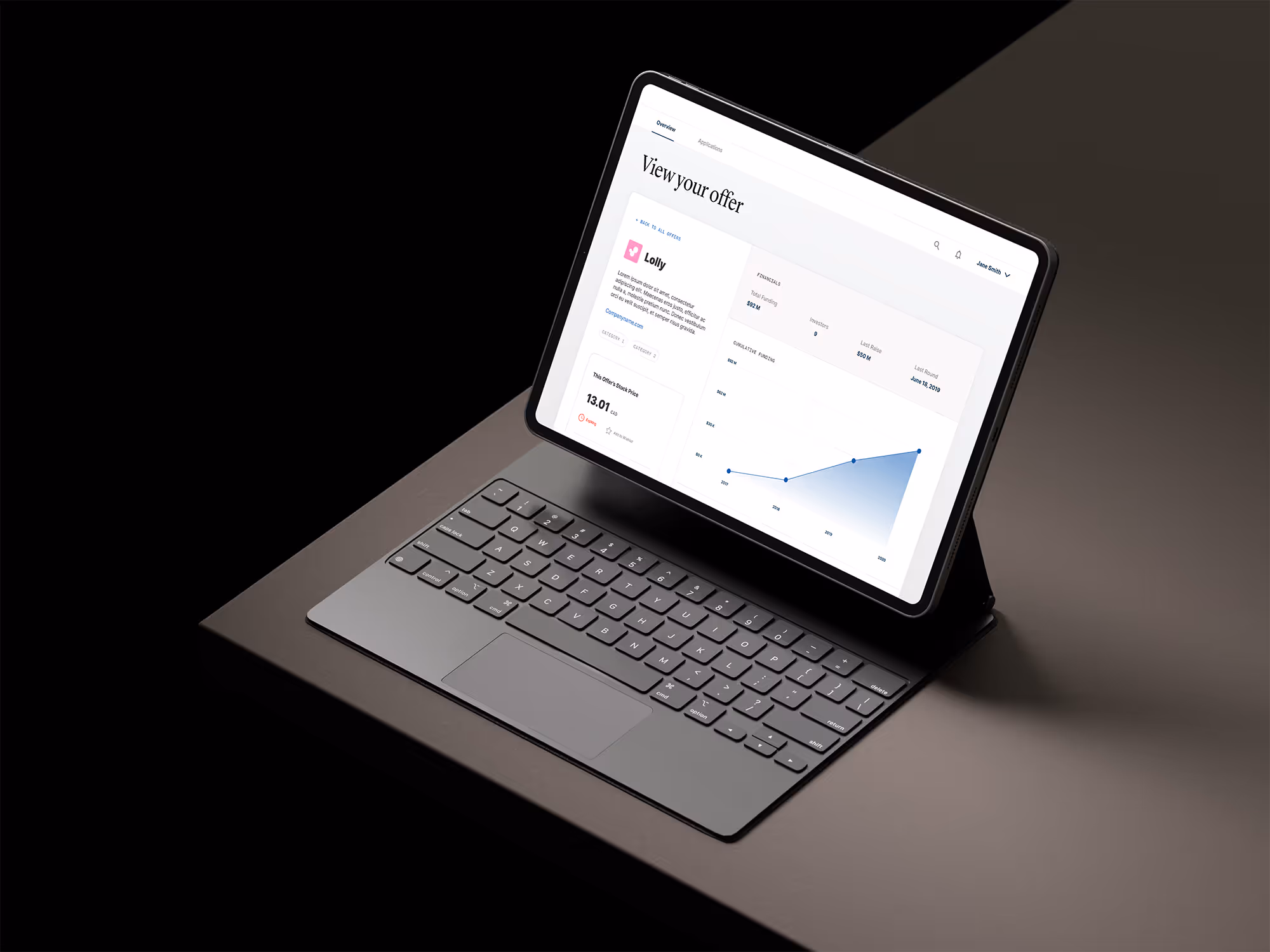 Tablet with keyboard displaying a financial dashboard interface on a dark surface with a black background.