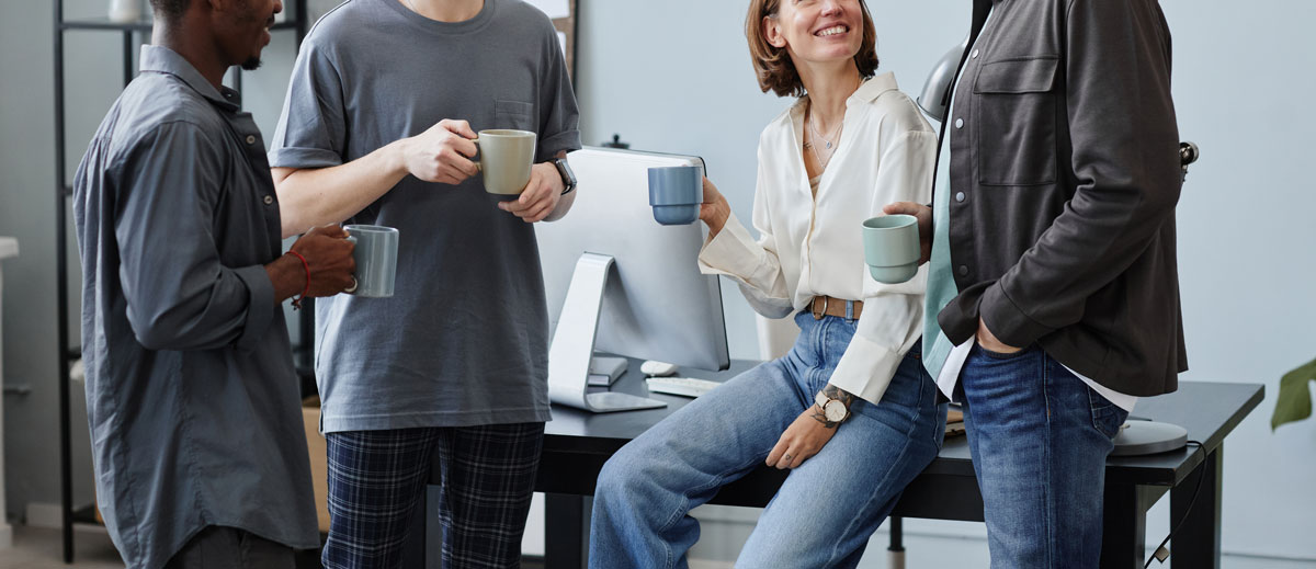 four employees enjoying coffee between break