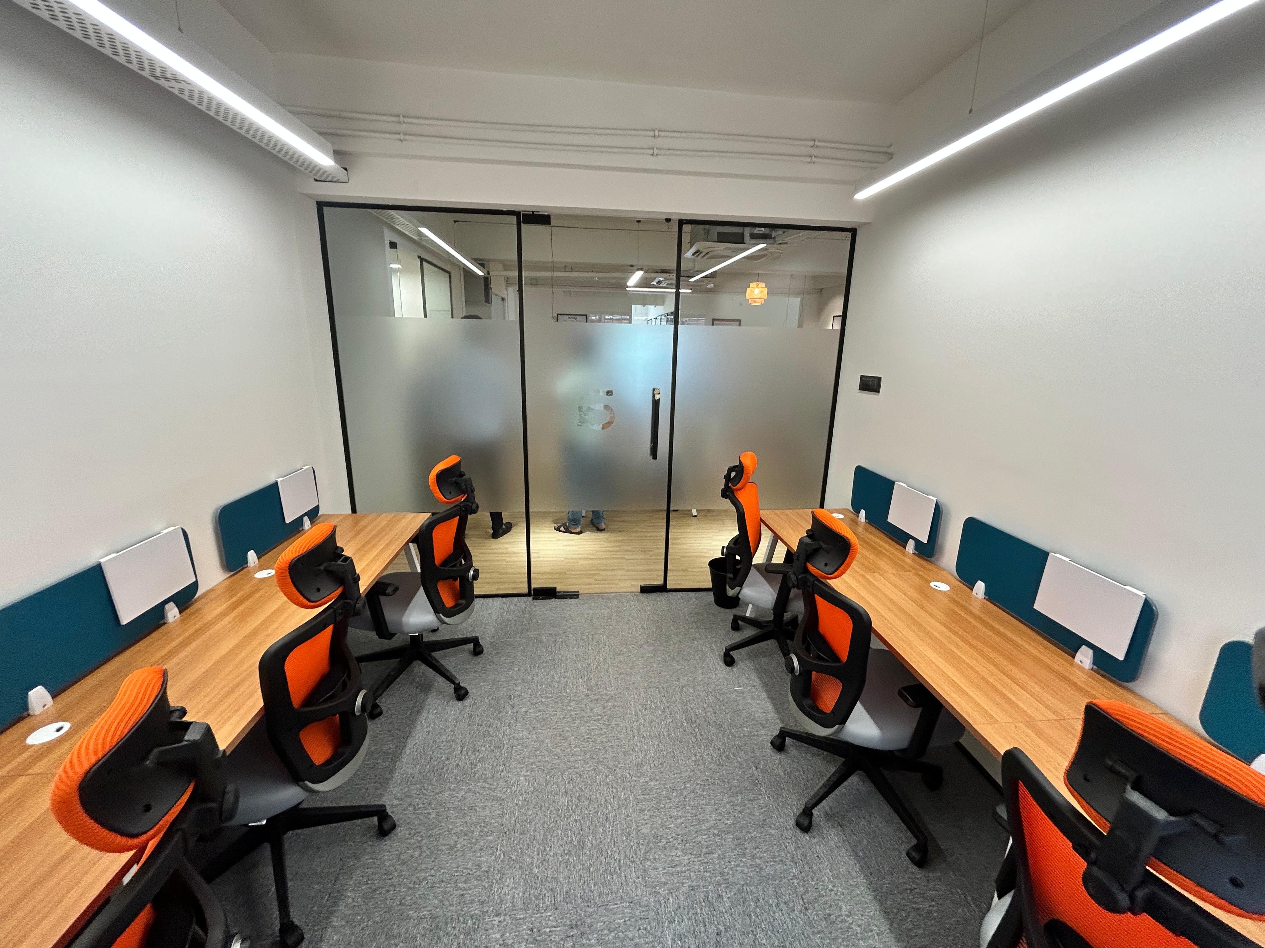 A six seater private cabin with 6 chairs and desks 