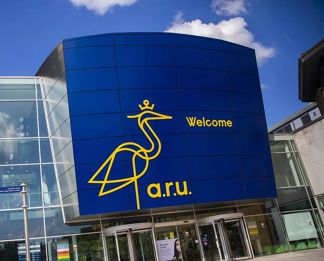 Anglia Ruskin University building with a blue facade and yellow university logo