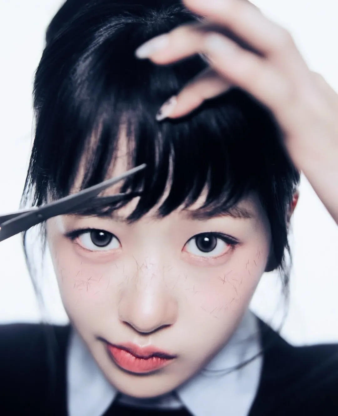 Close-up of K-pop idol cutting her bangs with scissors, focused expression and hair strands falling on her face.