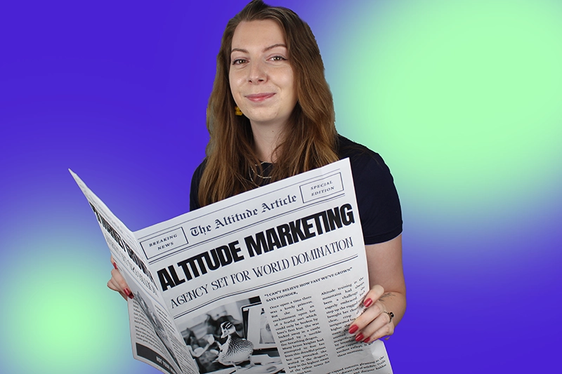 A Woman Holding A Newspaper