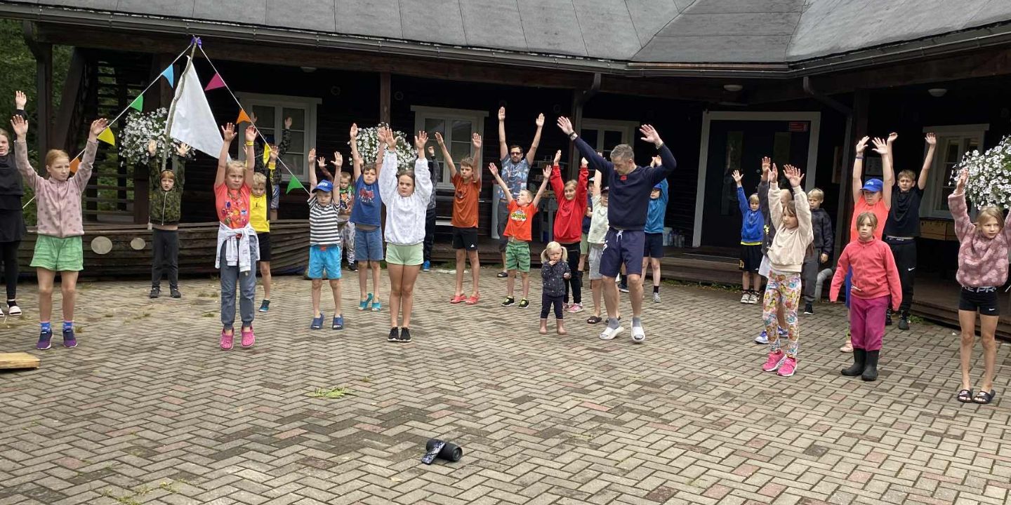 Bildet viser en gruppe barn som utfører morgengymnastikk