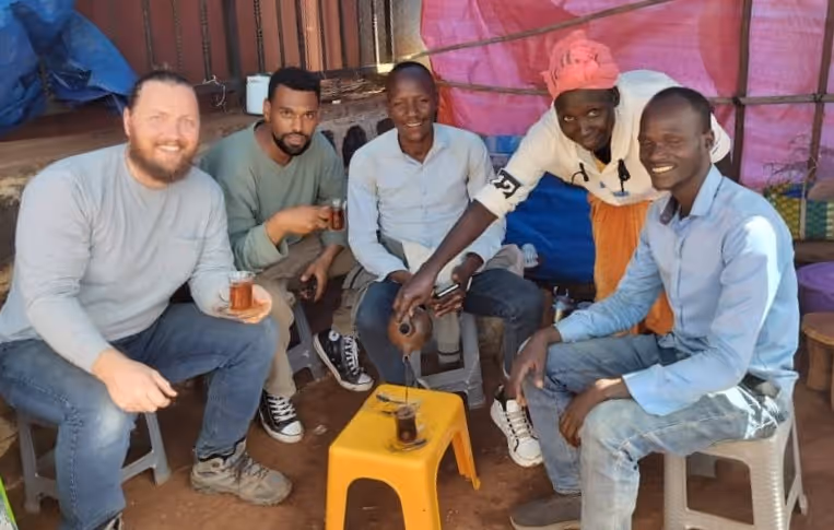 Bildet viser fem personer under en te-pause