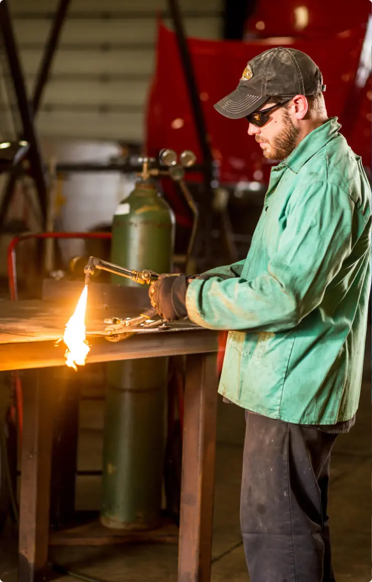 Man welding in a workshop.