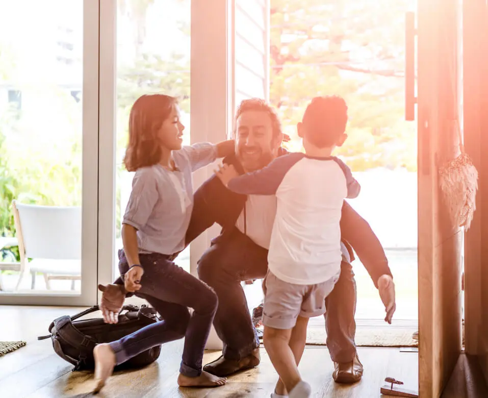 Family playing together in a sunlit living room.