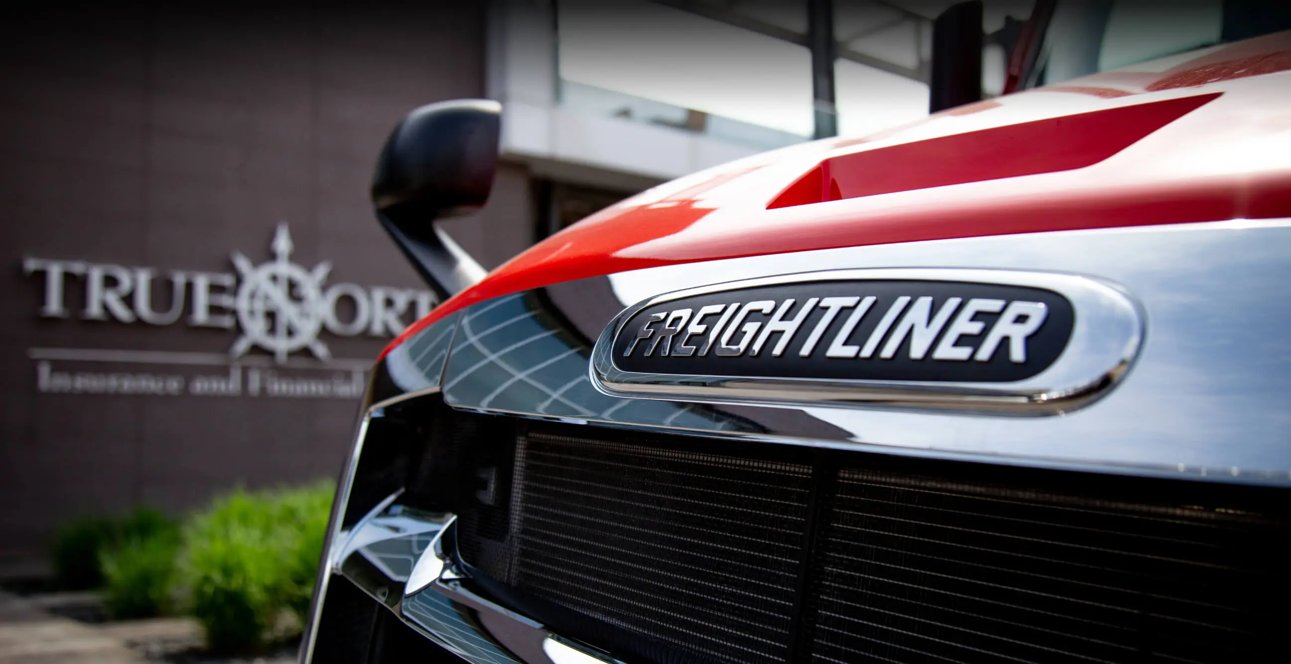 Close-up of a truck branded “True North Freightliner”.