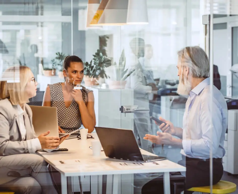 Business meeting with people in a modern office space.