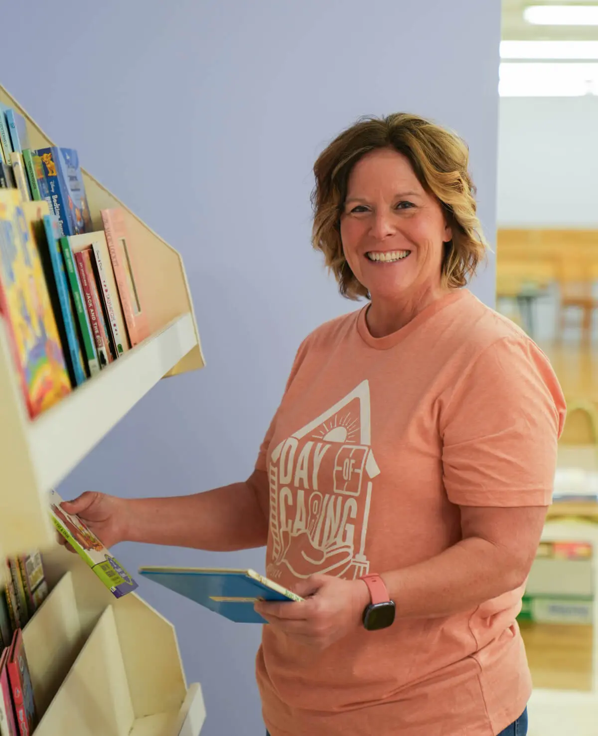 Woman organizing books in a library.