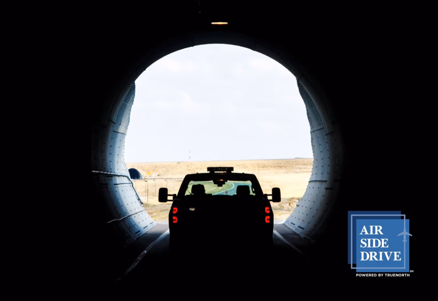 A truck driving airside.