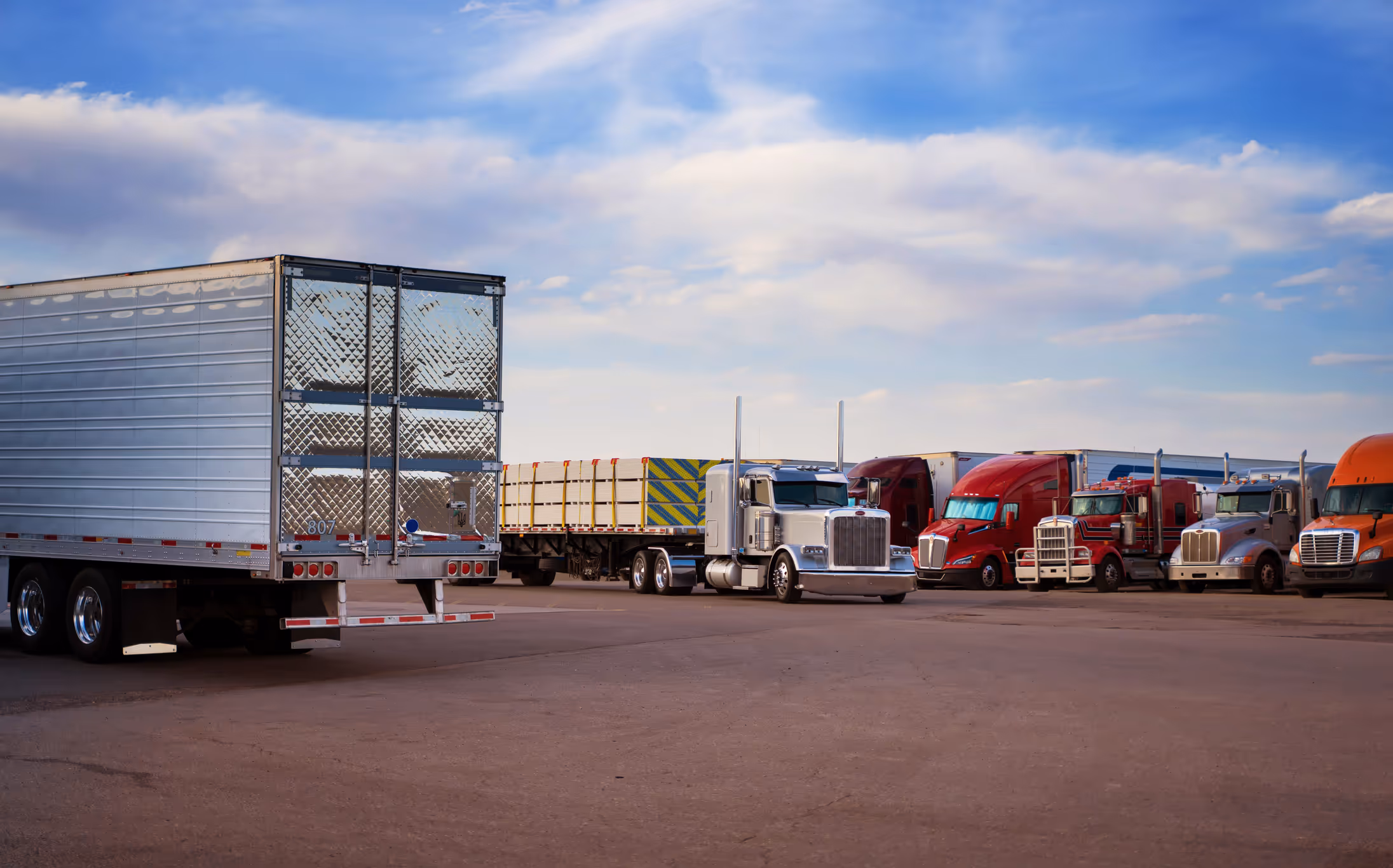 Semi trucks in parking lot.