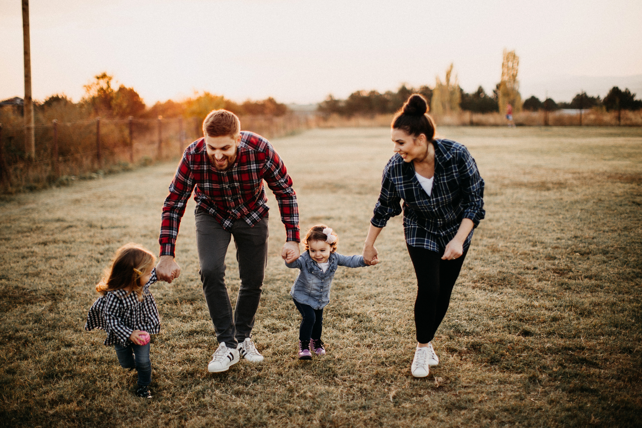 Parents with two young children holding hands