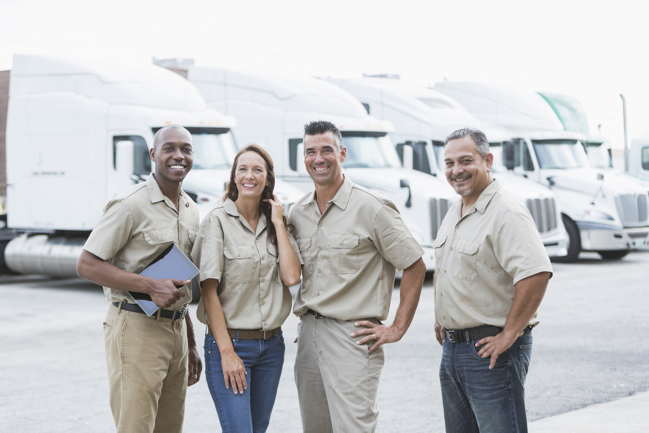 Group of motor carriers in front of semi trucks.