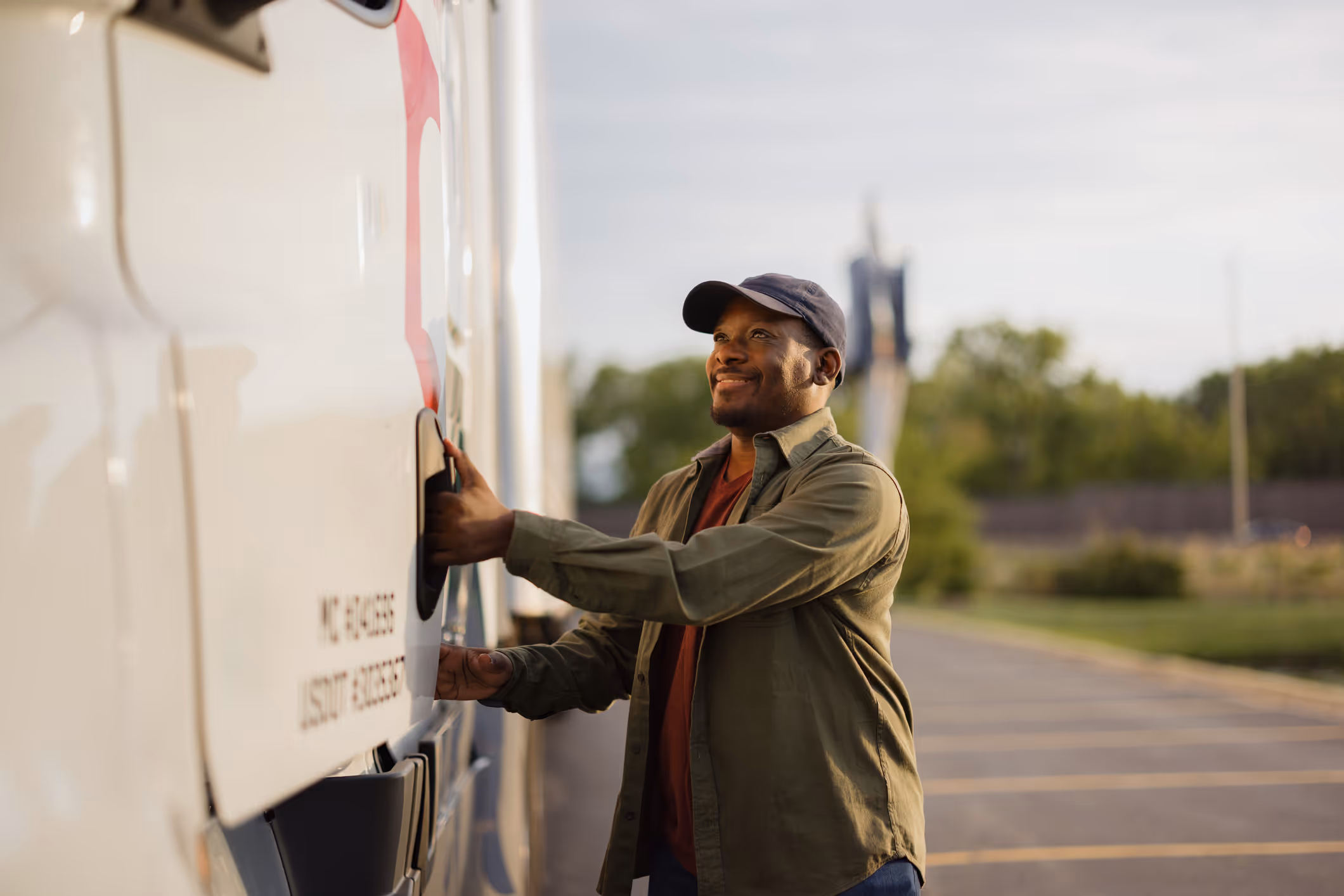 man opening cab of a semitruck