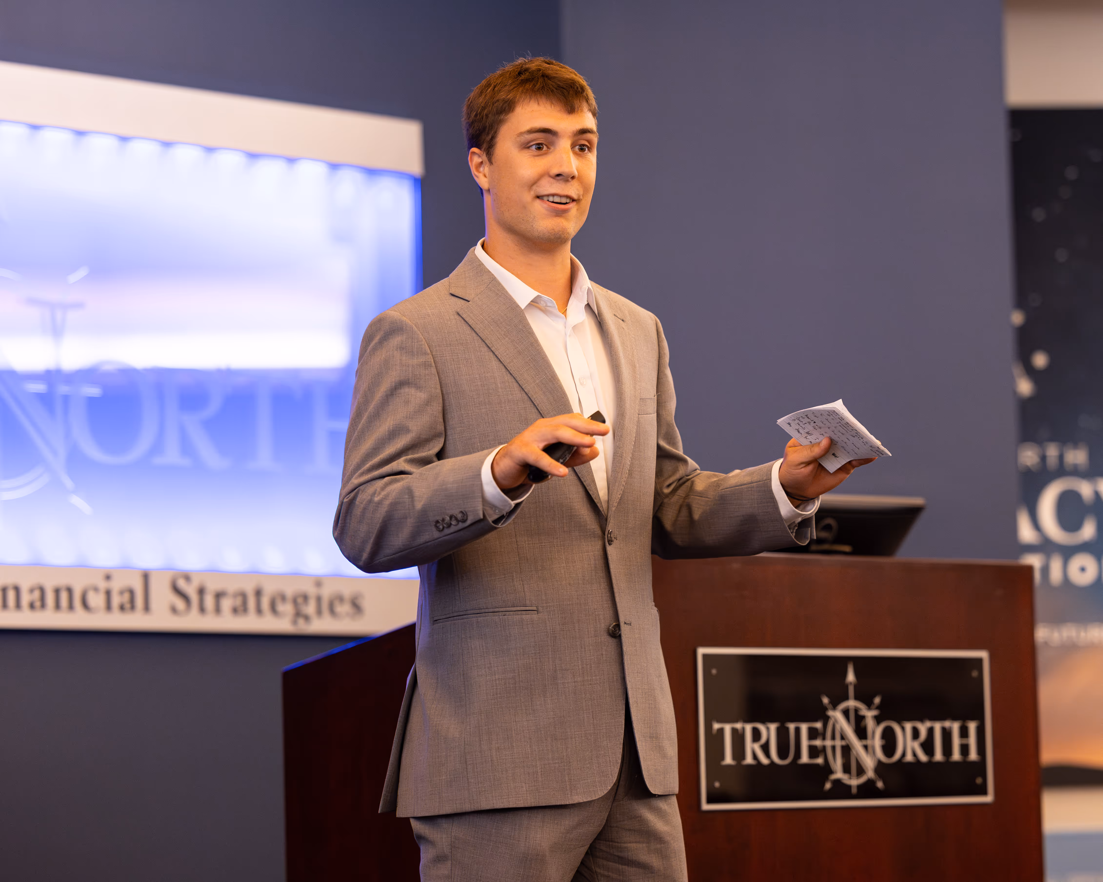 Truenorth intern presenting in front of podium